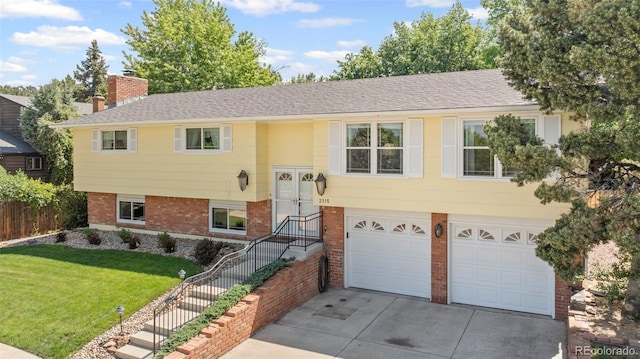2315 N Murray Blvd, Colorado Springs, CO 80915 - split foyer home featuring driveway, an attached garage, brick siding, a chimney, and a shingled roof