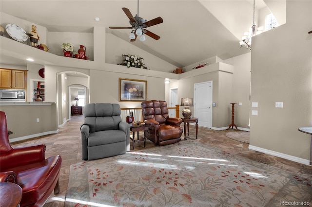 living room featuring ceiling fan and high vaulted ceiling