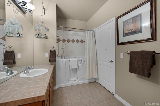 bathroom featuring tile patterned flooring, vanity, and walk in shower