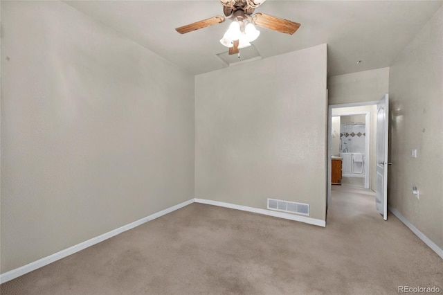 carpeted spare room with ceiling fan