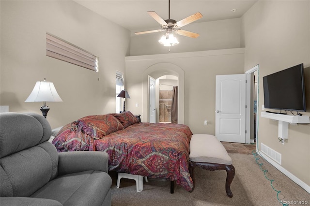 bedroom featuring carpet flooring, ceiling fan, and a towering ceiling