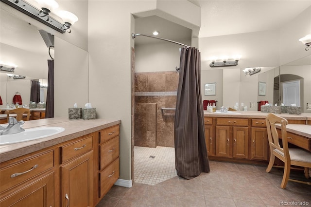 bathroom featuring a shower with shower curtain, tile patterned flooring, and vanity