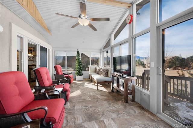 sunroom / solarium featuring vaulted ceiling with beams, plenty of natural light, and ceiling fan