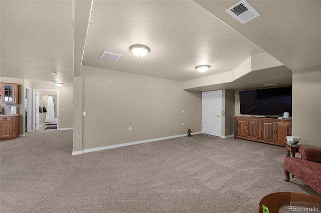 living room with light carpet and a textured ceiling