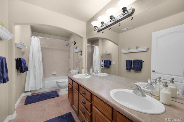 full bathroom featuring tile patterned flooring, vanity, shower / bath combo, and toilet