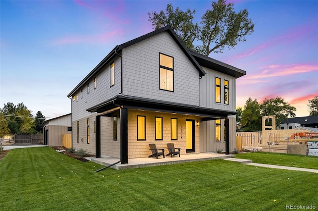 view of front of home with a yard and a patio area