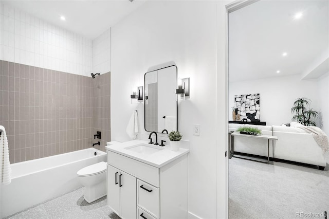 full bathroom featuring tiled shower / bath, toilet, and vanity