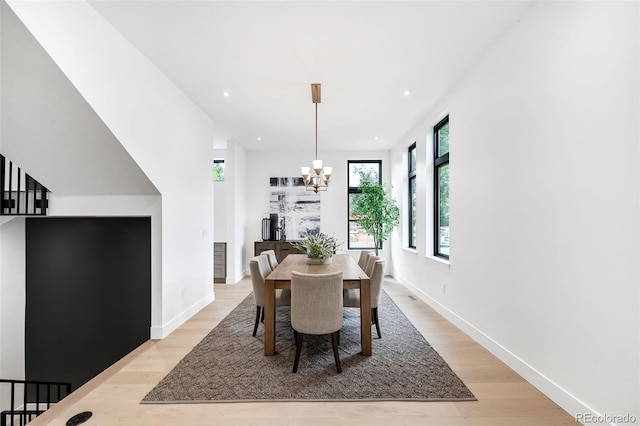 dining room with a chandelier and light hardwood / wood-style flooring