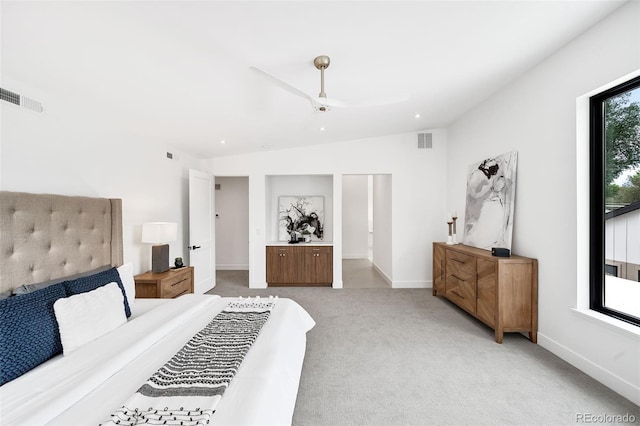 bedroom featuring ceiling fan, light carpet, and vaulted ceiling