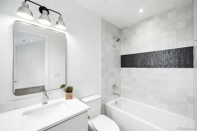 full bathroom with tiled shower / bath combo, vanity, and toilet