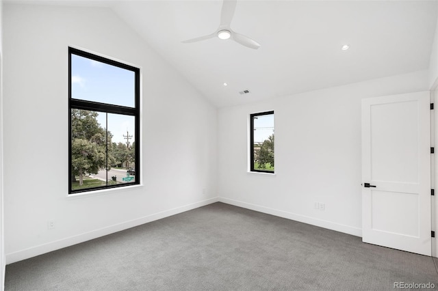 spare room featuring ceiling fan, carpet floors, and vaulted ceiling