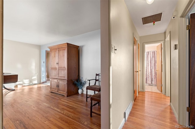 corridor with light hardwood / wood-style flooring