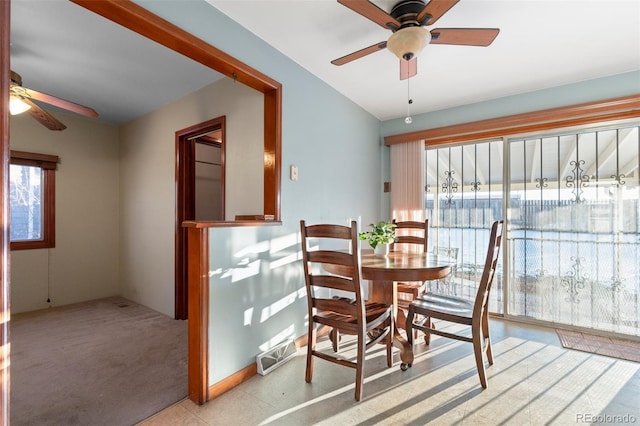 carpeted dining room featuring ceiling fan