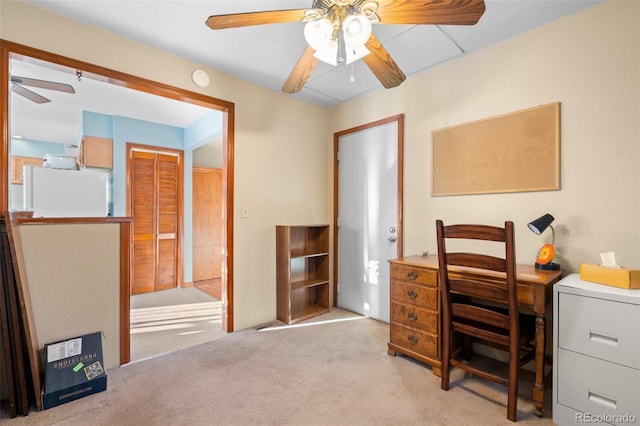 home office with light carpet and ceiling fan