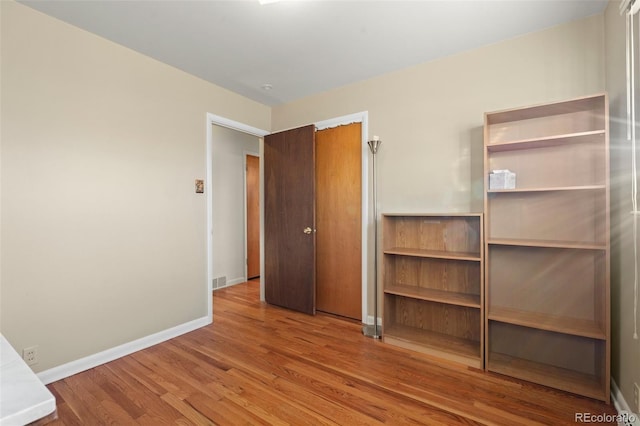 unfurnished bedroom with hardwood / wood-style floors