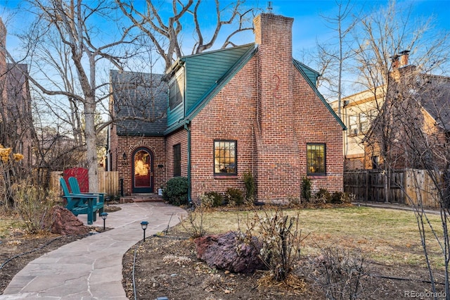 view of front of house with a patio and a front lawn