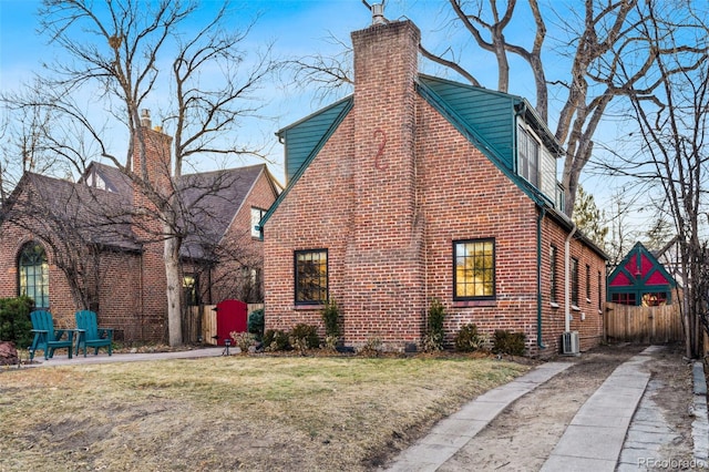 view of property exterior with central AC unit and a lawn