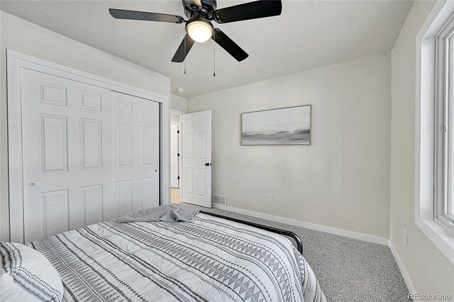 carpeted bedroom with a closet and ceiling fan