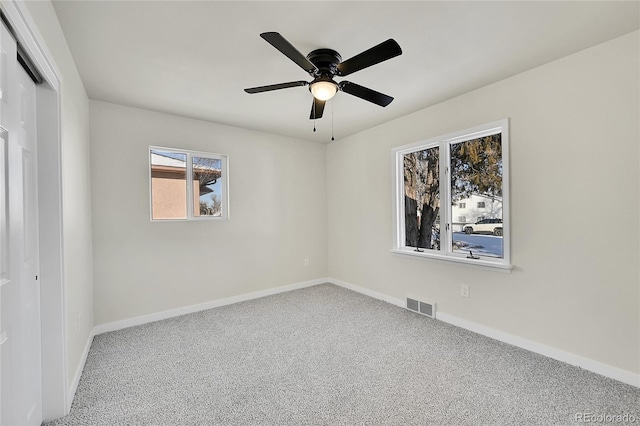 carpeted empty room featuring ceiling fan