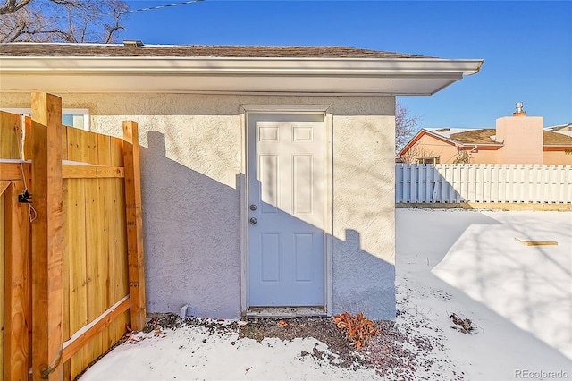 view of snow covered property entrance