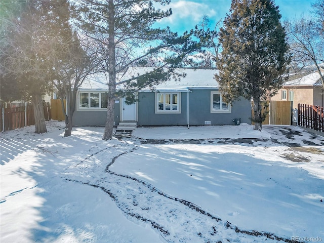 view of snow covered rear of property