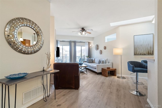1816 Montura Vw Unit 204, Colorado Springs, CO 80919 - living area featuring ceiling fan, visible vents, a skylight, wood finished floors, and baseboards