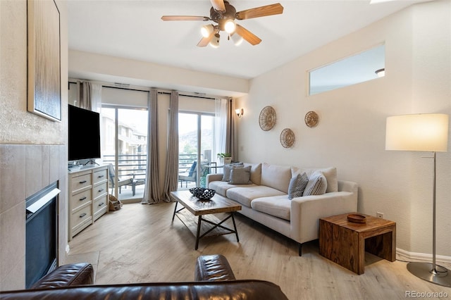 1816 Montura Vw Unit 204, Colorado Springs, CO 80919 - living room featuring light wood finished floors, baseboards, and a ceiling fan