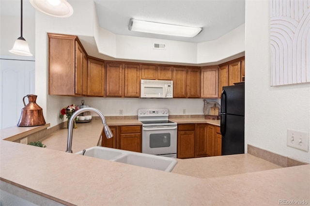 1816 Montura Vw Unit 204, Colorado Springs, CO 80919 - kitchen with white appliances, visible vents, light countertops, and a sink