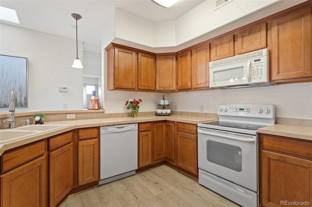 1816 Montura Vw Unit 204, Colorado Springs, CO 80919 - kitchen featuring brown cabinets, white appliances, and a sink