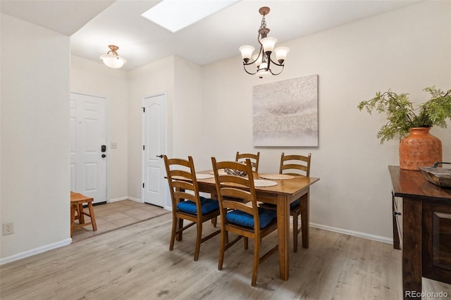 1816 Montura Vw Unit 204, Colorado Springs, CO 80919 - dining space with baseboards, light wood-type flooring, and a chandelier