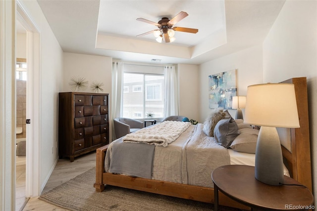 1816 Montura Vw Unit 204, Colorado Springs, CO 80919 - bedroom featuring visible vents, baseboards, a raised ceiling, ceiling fan, and light wood-style floors