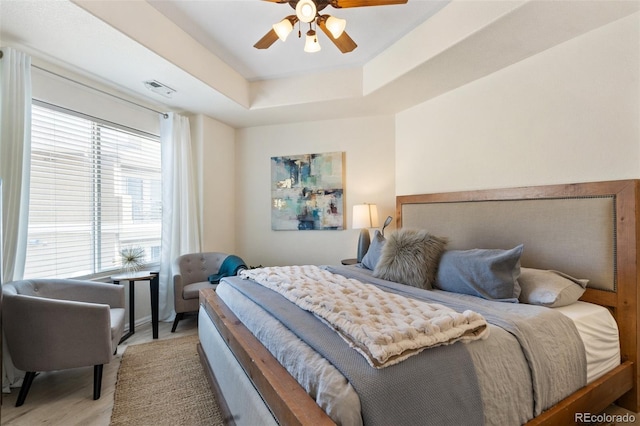 1816 Montura Vw Unit 204, Colorado Springs, CO 80919 - bedroom with a raised ceiling, wood finished floors, a ceiling fan, and visible vents