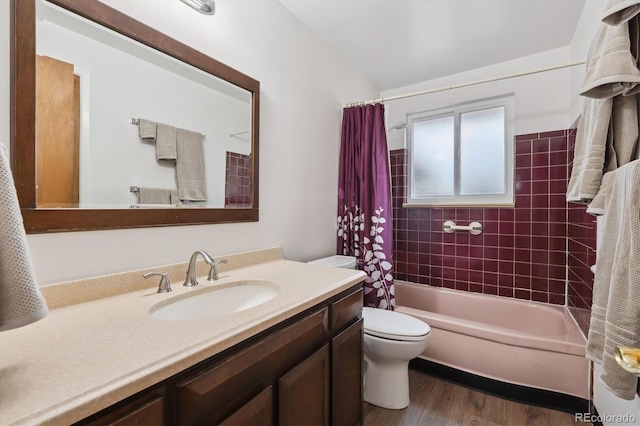 bathroom with vanity, shower / bathtub combination with curtain, toilet, and wood finished floors