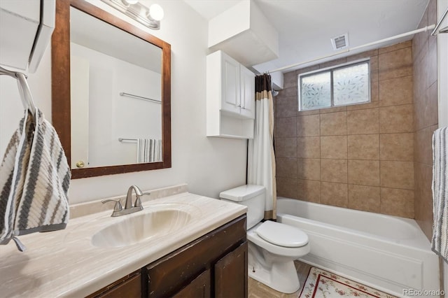 bathroom with visible vents, toilet, vanity, and shower / tub combo