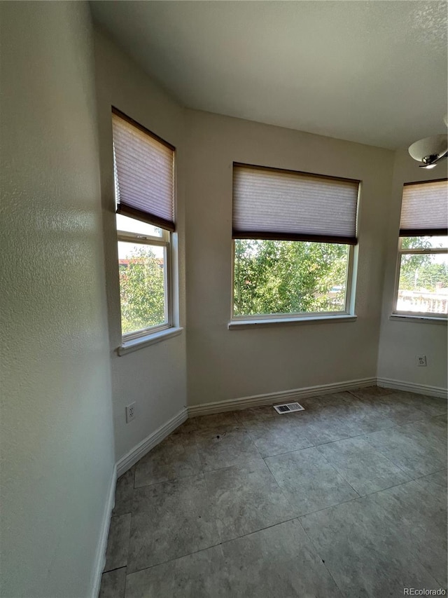 unfurnished room featuring a healthy amount of sunlight