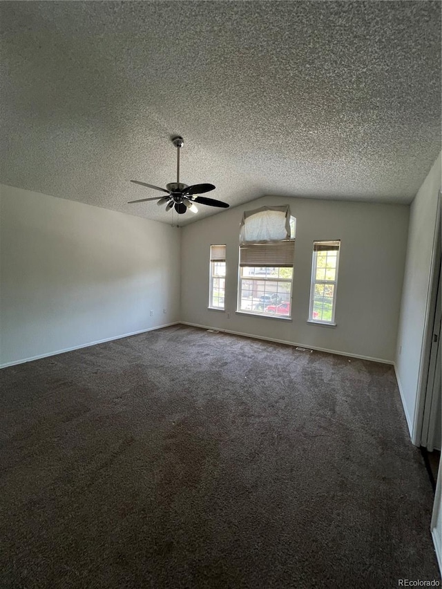 carpeted spare room with lofted ceiling, a textured ceiling, and ceiling fan