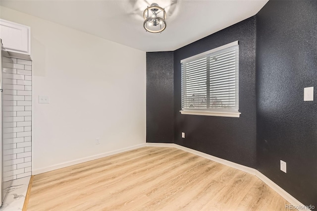 3200 S Federal Blvd Unit 5, Denver, CO 80236 - spare room featuring wood finished floors and baseboards