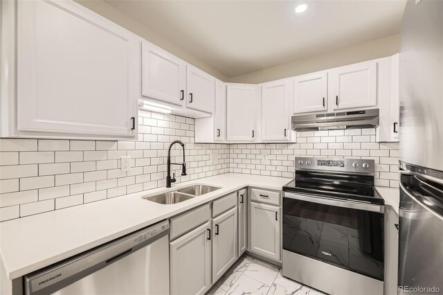 3200 S Federal Blvd Unit 5, Denver, CO 80236 - kitchen featuring stainless steel appliances, under cabinet range hood, light marble finish flooring, light countertops, and recessed lighting