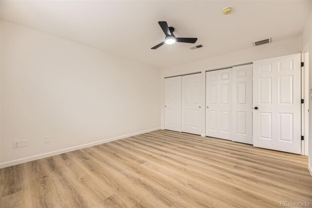 3200 S Federal Blvd Unit 5, Denver, CO 80236 - unfurnished bedroom featuring multiple closets, light wood-style floors, and a ceiling fan
