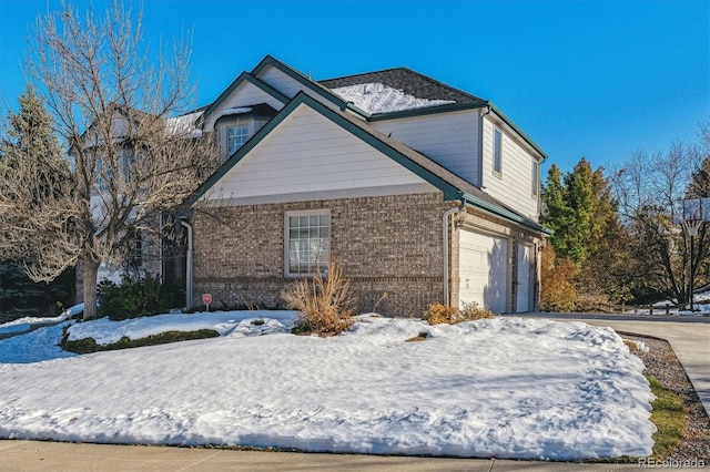 view of snow covered exterior featuring a garage