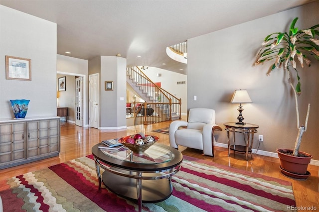 10834 Bobcat Ter, Lone Tree, CO 80124 - living area featuring stairway, wood finished floors, and recessed lighting