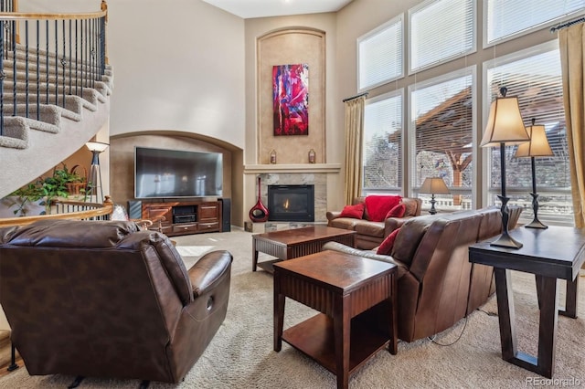 10834 Bobcat Ter, Lone Tree, CO 80124 - carpeted living area featuring a high ceiling, a tile fireplace, and stairway