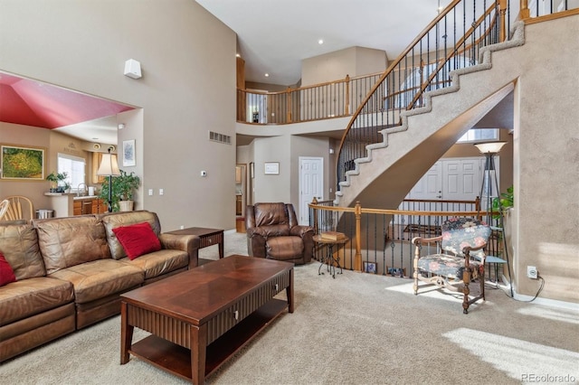 10834 Bobcat Ter, Lone Tree, CO 80124 - living area with carpet flooring, a towering ceiling, and stairway