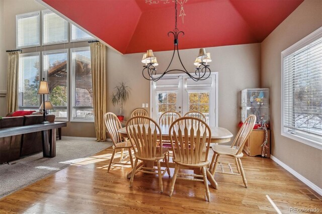 10834 Bobcat Ter, Lone Tree, CO 80124 - dining room with vaulted ceiling, a chandelier, and light wood-style floors