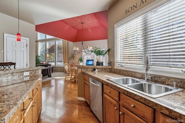 10834 Bobcat Ter, Lone Tree, CO 80124 - kitchen with stainless steel dishwasher, lofted ceiling, a chandelier, light wood-type flooring, and decorative light fixtures