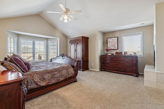 carpeted bedroom featuring multiple windows, ceiling fan, and vaulted ceiling