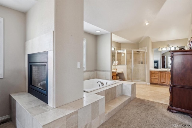 bathroom with separate shower and tub, tile patterned flooring, and vanity