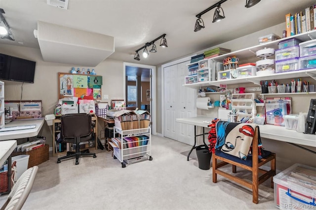 carpeted home office with rail lighting