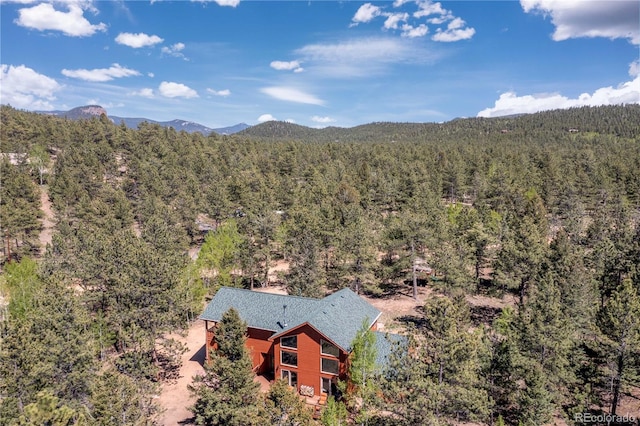 aerial view featuring a mountain view and a wooded view