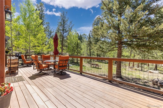 wooden terrace with outdoor dining space